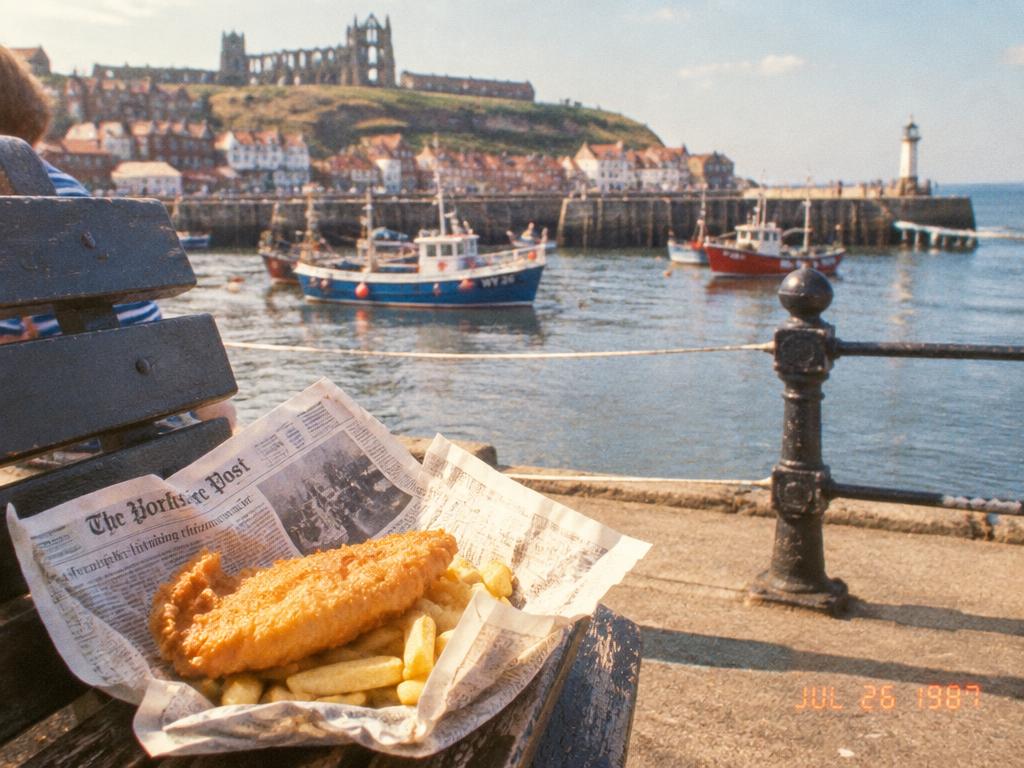 A family-style photograph of fish and chips at Whitby harbour